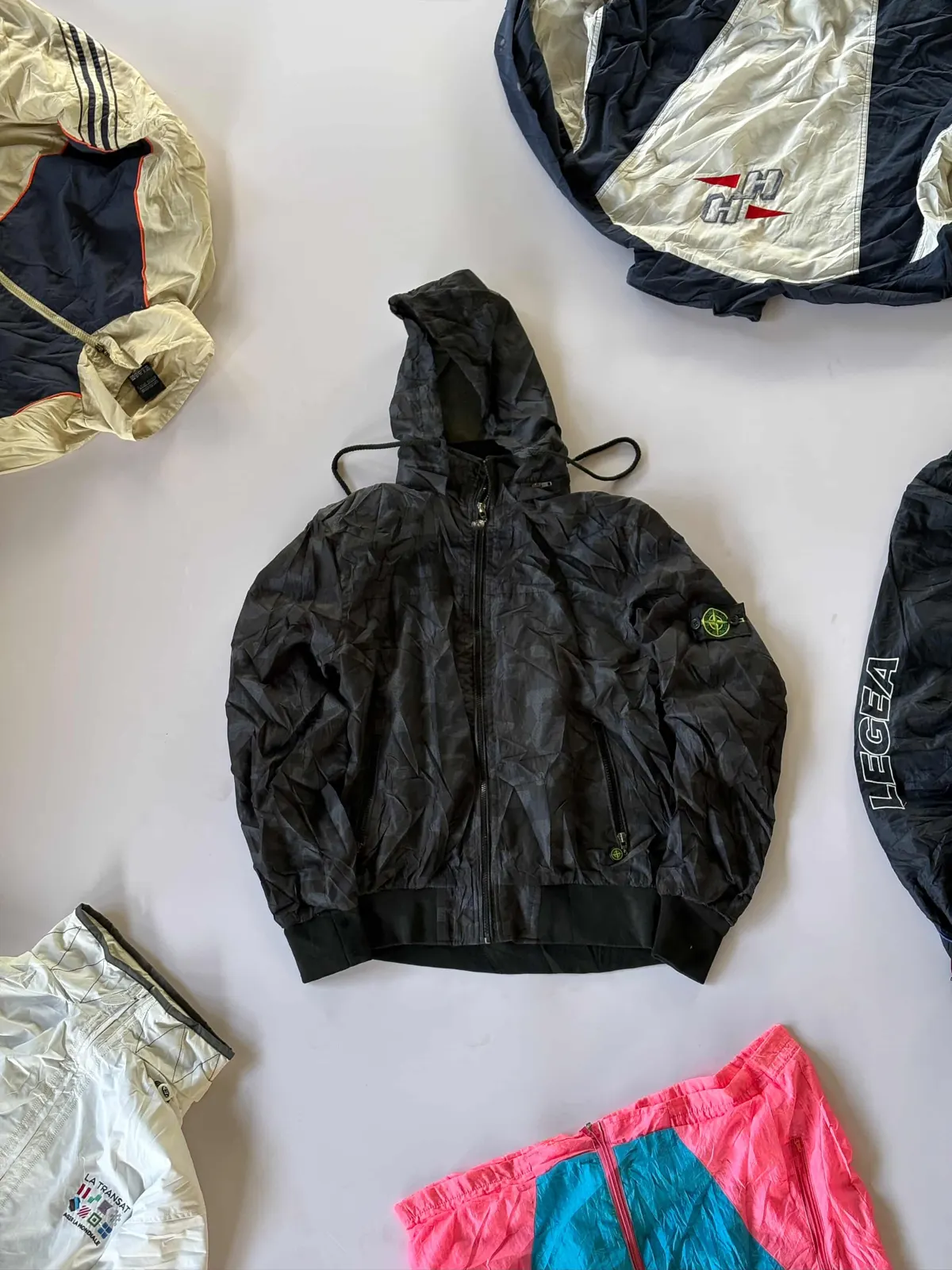 Black Hooded Shell, black tonal shell laid flat