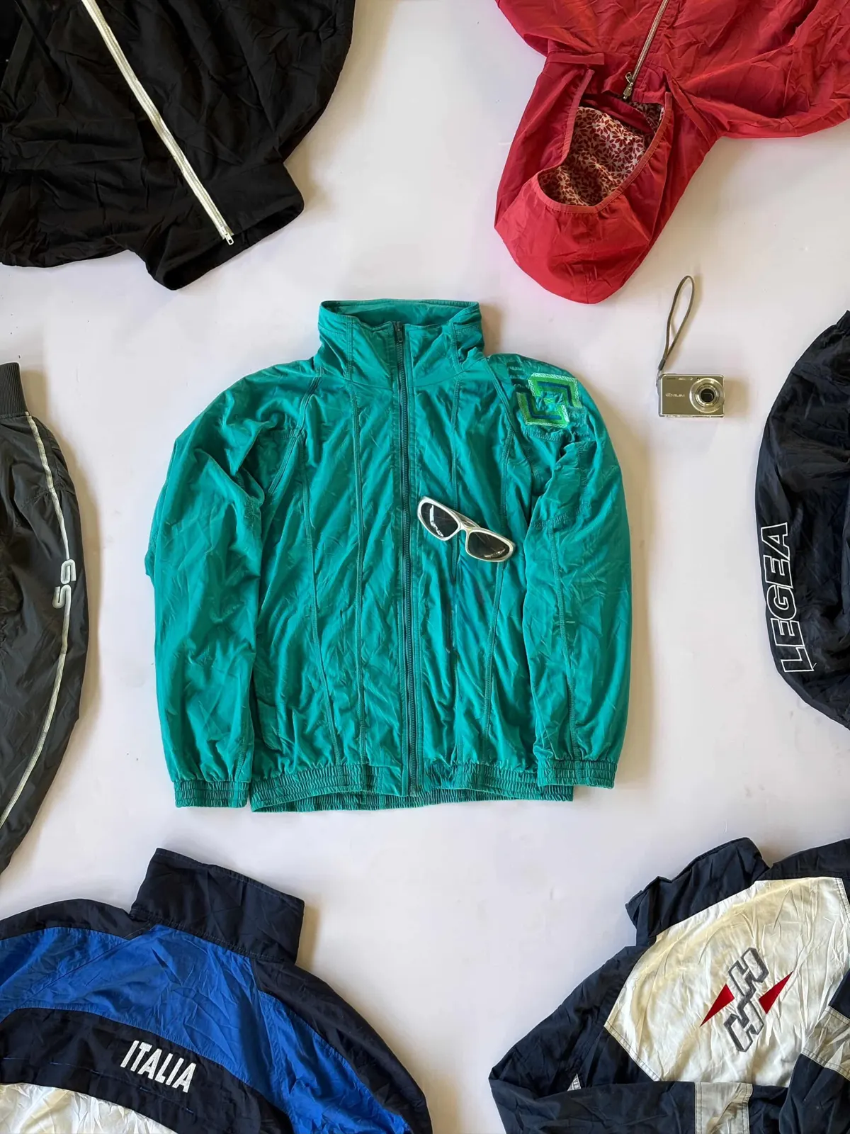 Teal Windbreaker, teal windbreaker laid flat